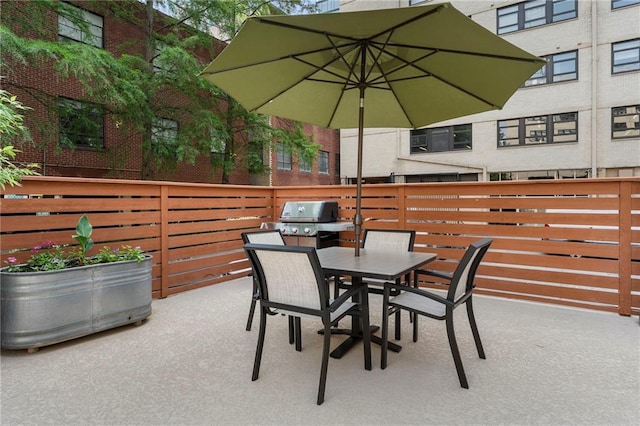 view of patio / terrace with fence, outdoor dining area, and area for grilling