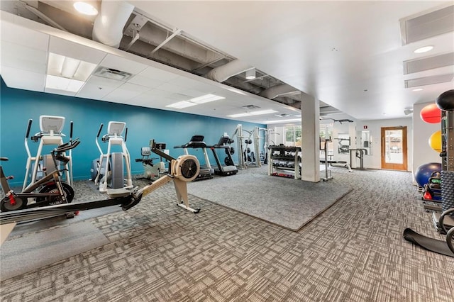 exercise room with carpet floors and baseboards