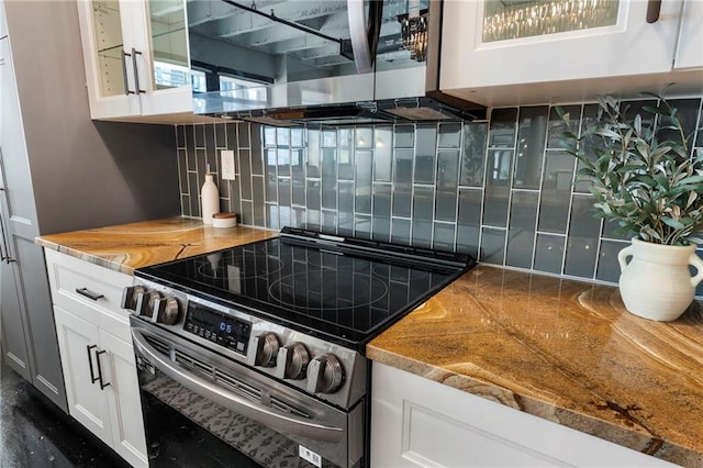 kitchen featuring stainless steel appliances, decorative backsplash, white cabinets, and glass insert cabinets