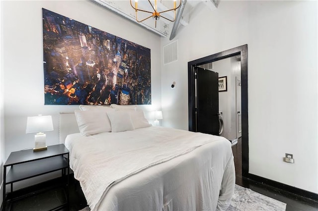 bedroom featuring a chandelier and baseboards