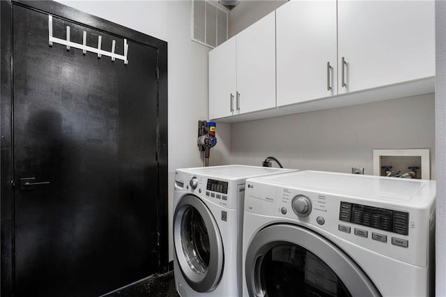 laundry area featuring cabinet space and washing machine and clothes dryer