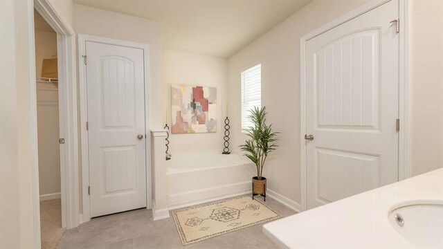 bathroom with vanity and a tub to relax in