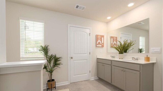 full bath featuring recessed lighting, visible vents, a sink, and double vanity