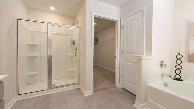 bathroom featuring independent shower and bath and tile patterned flooring