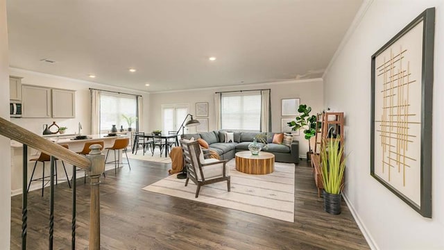 living room with dark wood-style floors, recessed lighting, visible vents, ornamental molding, and baseboards