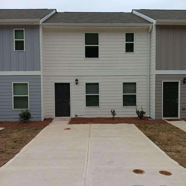 view of front facade with a patio and a front lawn