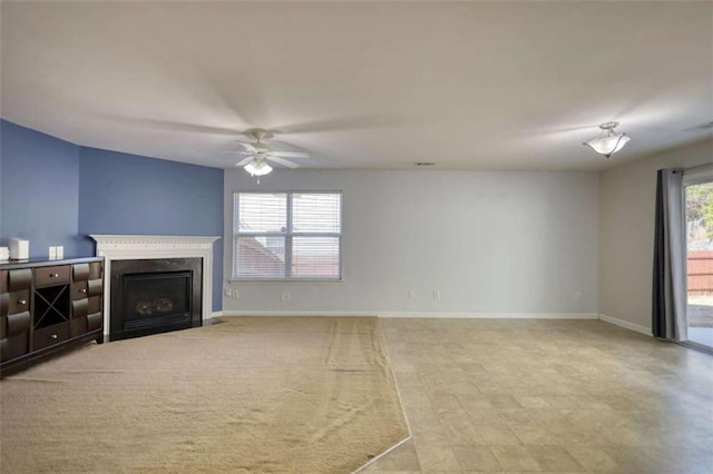 living room with a premium fireplace and ceiling fan