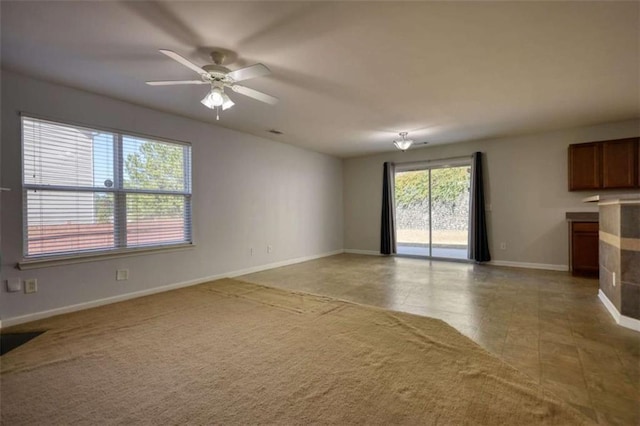 unfurnished living room with tile patterned floors and ceiling fan