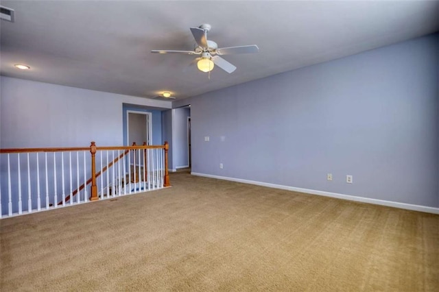 empty room featuring ceiling fan and carpet