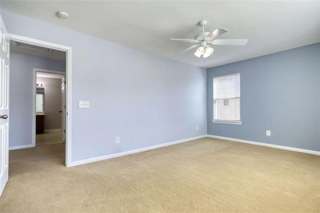 spare room with ceiling fan and light carpet