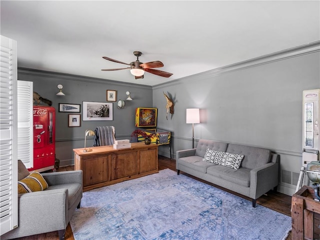 office space with crown molding, baseboards, a ceiling fan, and wood finished floors