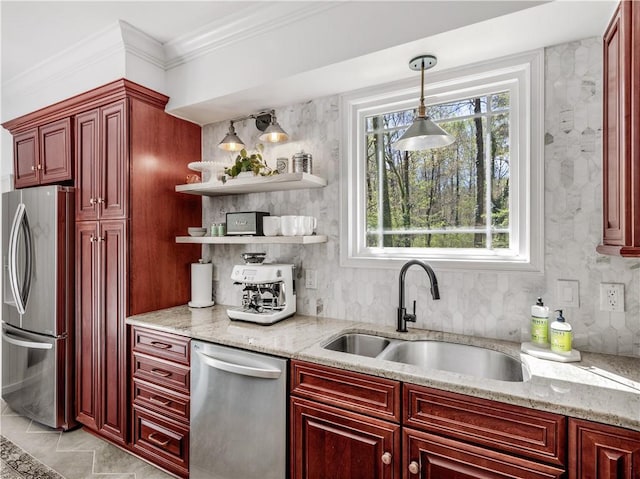 kitchen featuring appliances with stainless steel finishes, a sink, and reddish brown cabinets
