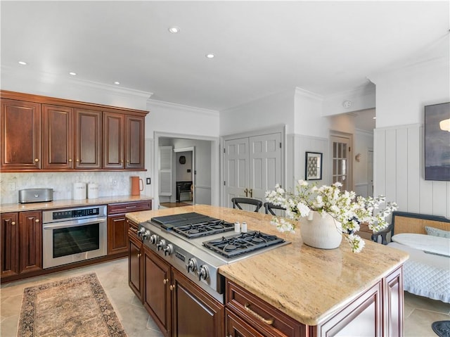 kitchen featuring crown molding, light stone countertops, recessed lighting, tasteful backsplash, and appliances with stainless steel finishes
