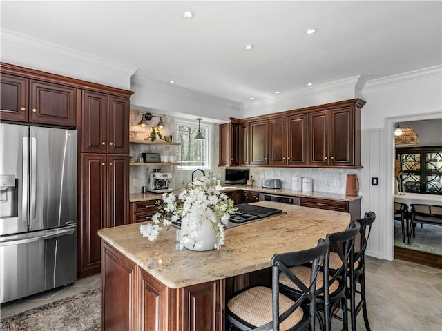 kitchen featuring crown molding, stainless steel fridge with ice dispenser, decorative backsplash, and a center island