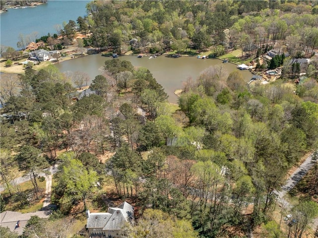 aerial view with a water view and a wooded view