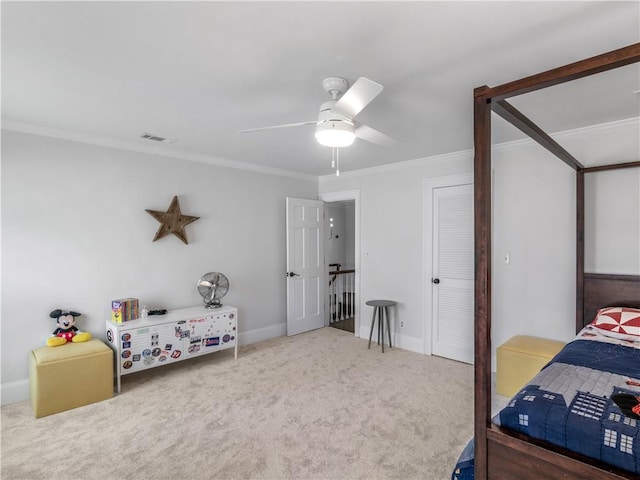 bedroom with a ceiling fan, visible vents, crown molding, carpet floors, and baseboards