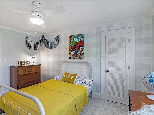 bedroom featuring carpet, wallpapered walls, baseboards, ornamental molding, and a closet