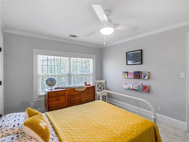 carpeted bedroom featuring crown molding, baseboards, a ceiling fan, and visible vents