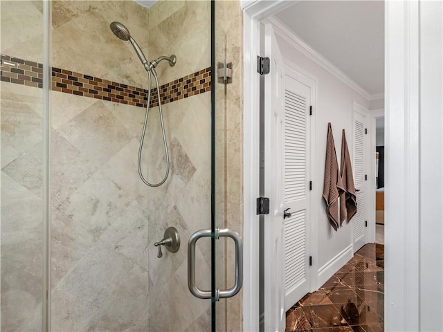 full bath with ornamental molding, marble finish floor, and a stall shower