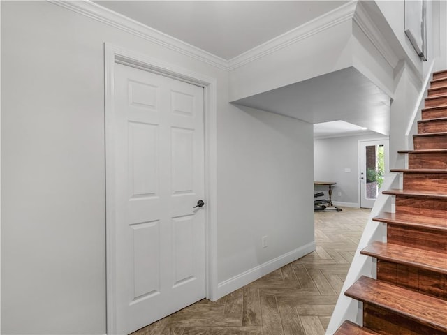staircase featuring crown molding and baseboards