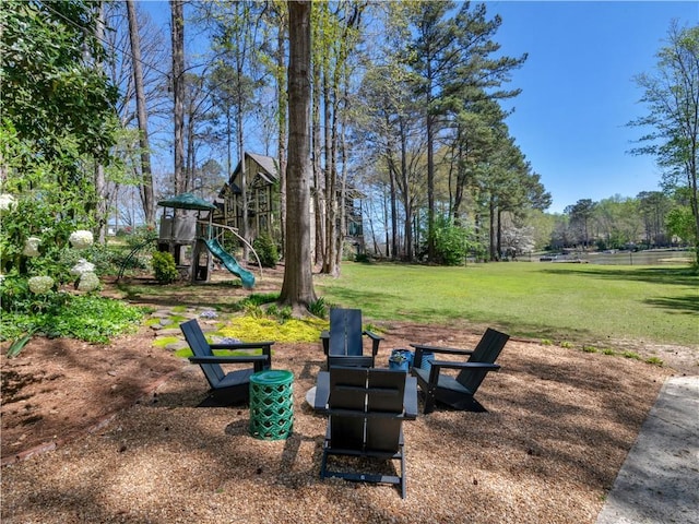 view of yard with a playground and an outdoor fire pit