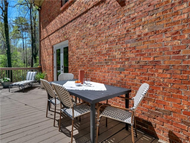 wooden deck with french doors and outdoor dining space