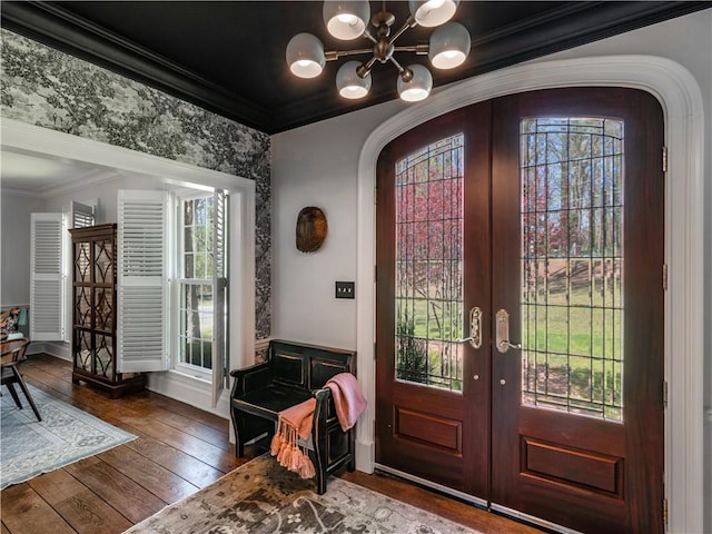 entryway featuring a healthy amount of sunlight, arched walkways, french doors, and a notable chandelier