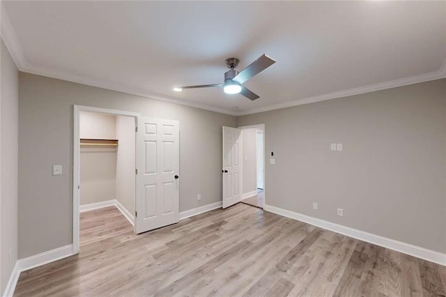 unfurnished bedroom with baseboards, crown molding, and light wood finished floors