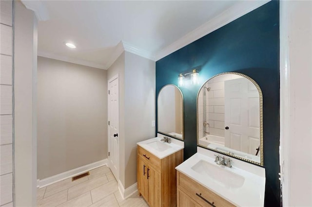 bathroom with visible vents, ornamental molding, baseboards, and a sink