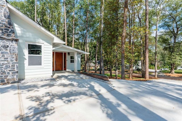 view of property exterior with stone siding