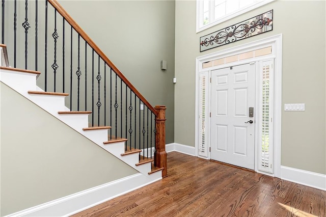 176 Nightwind Trce, Acworth, GA 30101 - foyer entrance with wood finished floors, baseboards, stairway, a high ceiling, and plenty of natural light