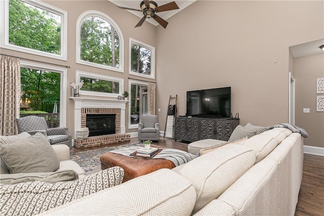 176 Nightwind Trce, Acworth, GA 30101 - living area with high vaulted ceiling, dark wood finished floors, ceiling fan, healthy amount of natural light, and a brick fireplace