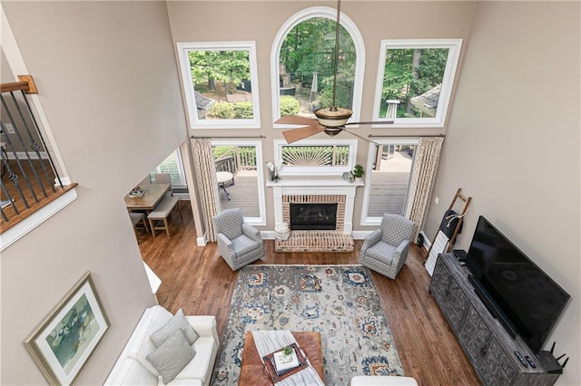 176 Nightwind Trce, Acworth, GA 30101 - living room with a high ceiling, ceiling fan, a fireplace, and wood finished floors
