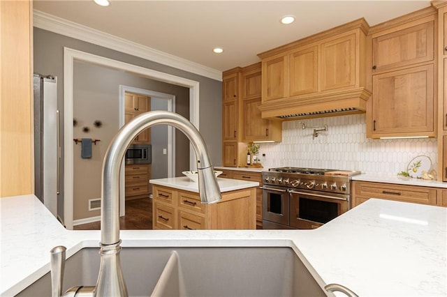 176 Nightwind Trce, Acworth, GA 30101 - kitchen with stainless steel appliances, crown molding, backsplash, recessed lighting, and a center island