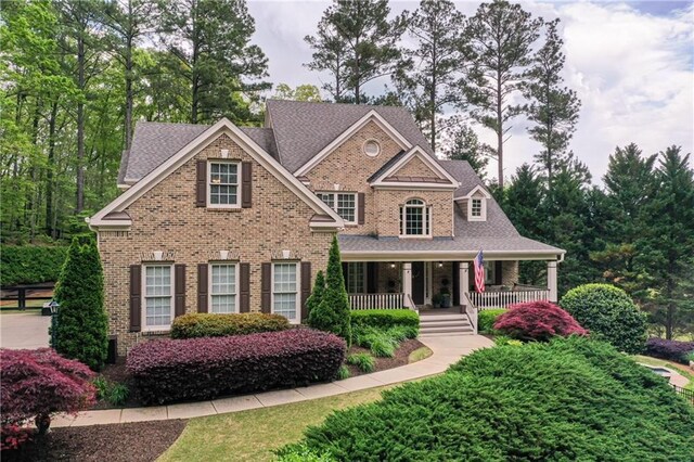 176 Nightwind Trce, Acworth, GA 30101 - view of front of property featuring brick siding, covered porch, and roof with shingles