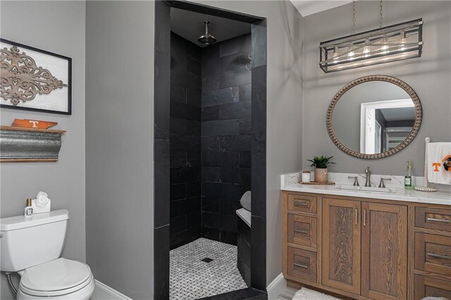 176 Nightwind Trce, Acworth, GA 30101 - bathroom featuring tiled shower, vanity, toilet, and baseboards