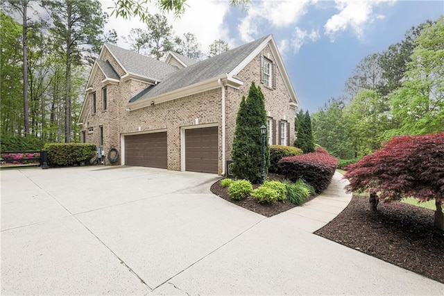 176 Nightwind Trce, Acworth, GA 30101 - view of property exterior with concrete driveway, brick siding, and a garage