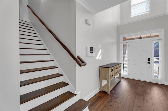 foyer entrance featuring baseboards, stairway, and hardwood / wood-style floors