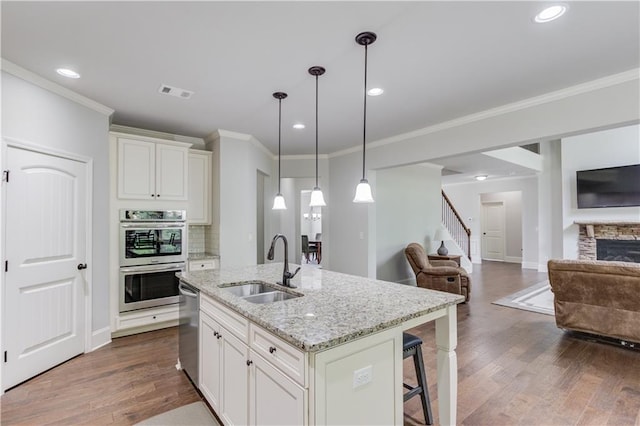 4241 Summer Breeze Way, Buford, GA 30518 - kitchen with open floor plan, appliances with stainless steel finishes, a sink, dark wood-style flooring, and a breakfast bar area