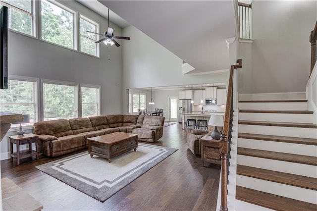 4241 Summer Breeze Way, Buford, GA 30518 - living area featuring ceiling fan, a high ceiling, healthy amount of natural light, stairs, and dark wood-style floors