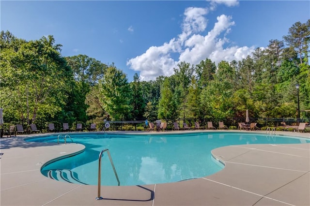 4241 Summer Breeze Way, Buford, GA 30518 - community pool featuring a patio and view of scattered trees