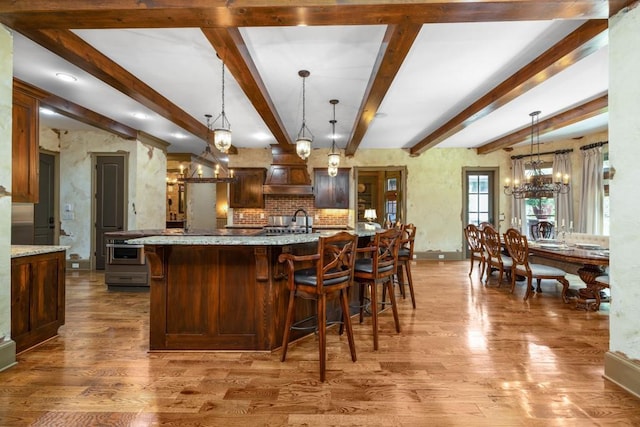 2740 Drayton Hall Dr, Buford, GA 30519 - kitchen featuring wood finished floors, an inviting chandelier, a sink, and light stone countertops