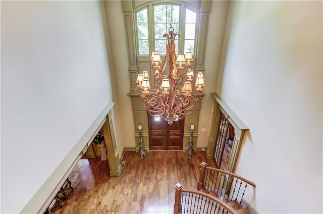 2740 Drayton Hall Dr, Buford, GA 30519 - foyer featuring a chandelier, wood finished floors, a towering ceiling, and stairway