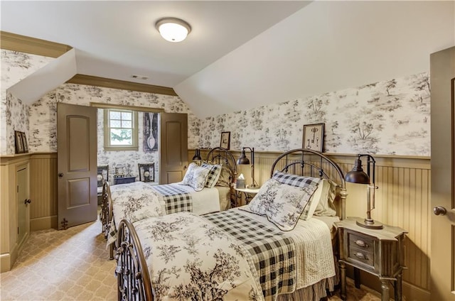 2740 Drayton Hall Dr, Buford, GA 30519 - bedroom with visible vents, vaulted ceiling, wallpapered walls, and a wainscoted wall