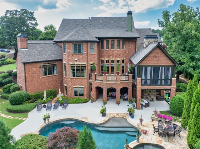 2740 Drayton Hall Dr, Buford, GA 30519 - back of property featuring a chimney, a patio area, and brick siding