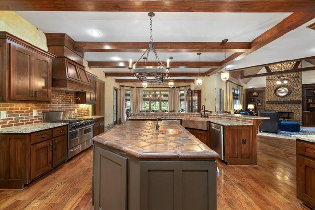 2740 Drayton Hall Dr, Buford, GA 30519 - kitchen with open floor plan, wood finished floors, a spacious island, and stainless steel appliances