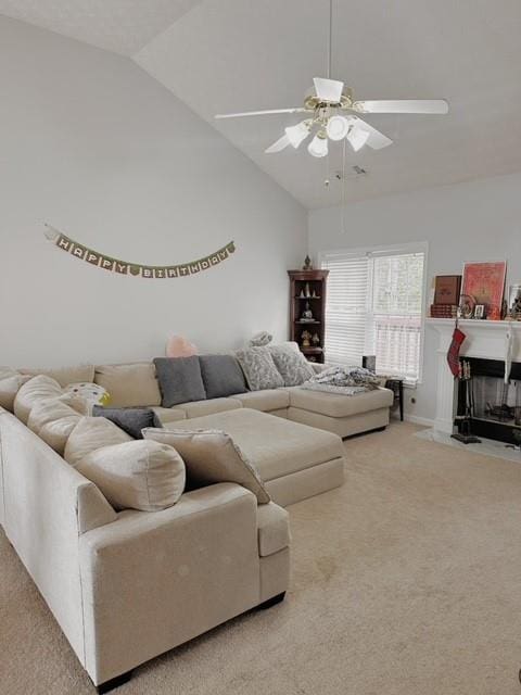 living room with vaulted ceiling, carpet, and ceiling fan