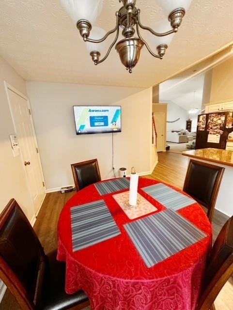 dining space featuring lofted ceiling and wood-type flooring