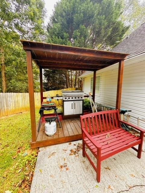 view of patio featuring a deck and a grill