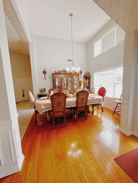 dining area with a notable chandelier and hardwood / wood-style floors